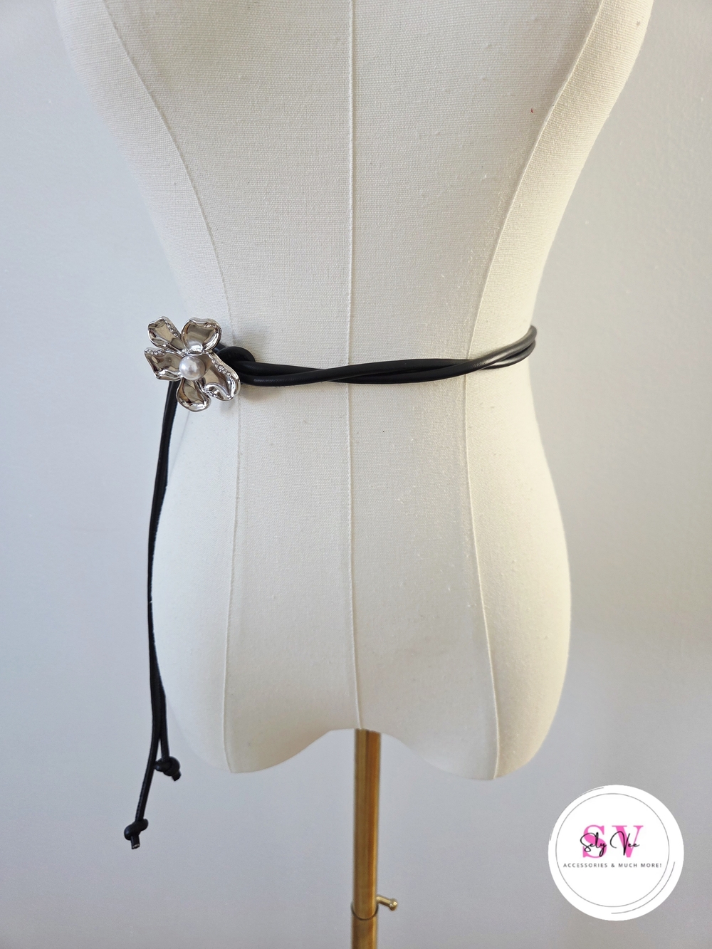 Black rope belt with silver brooch decor